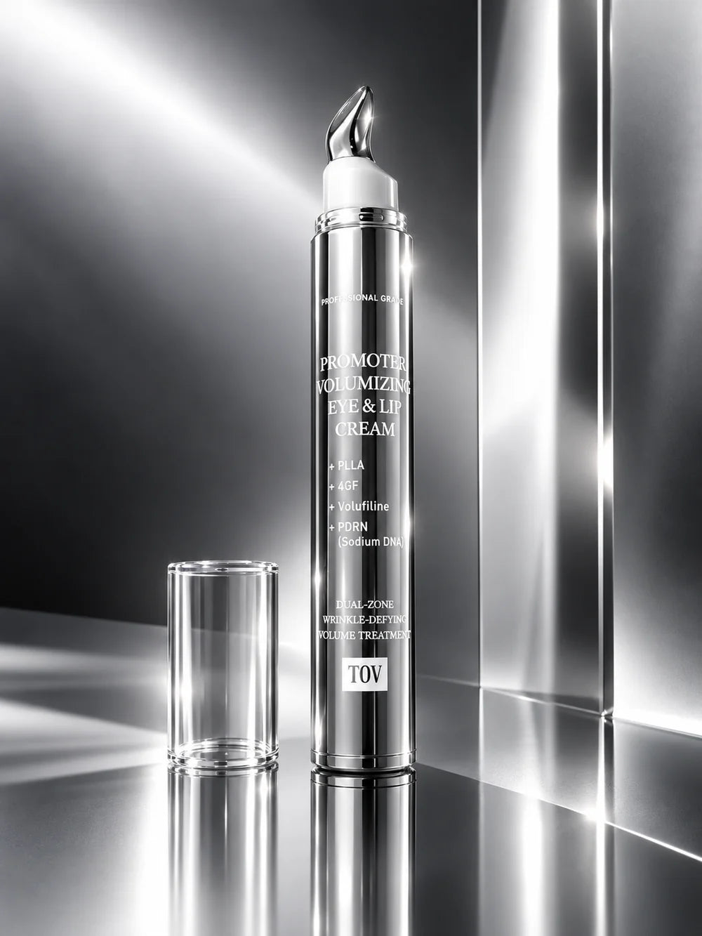 A sleek cylindrical cosmetic bottle labeled 'Promoting Proliferating Eye & Lip Cream' with its cap removed and placed beside it on a reflective metallic surface. The bottle is silver with white text and a white applicator tip, set against a dramatic black-and-silver studio background with light beams.