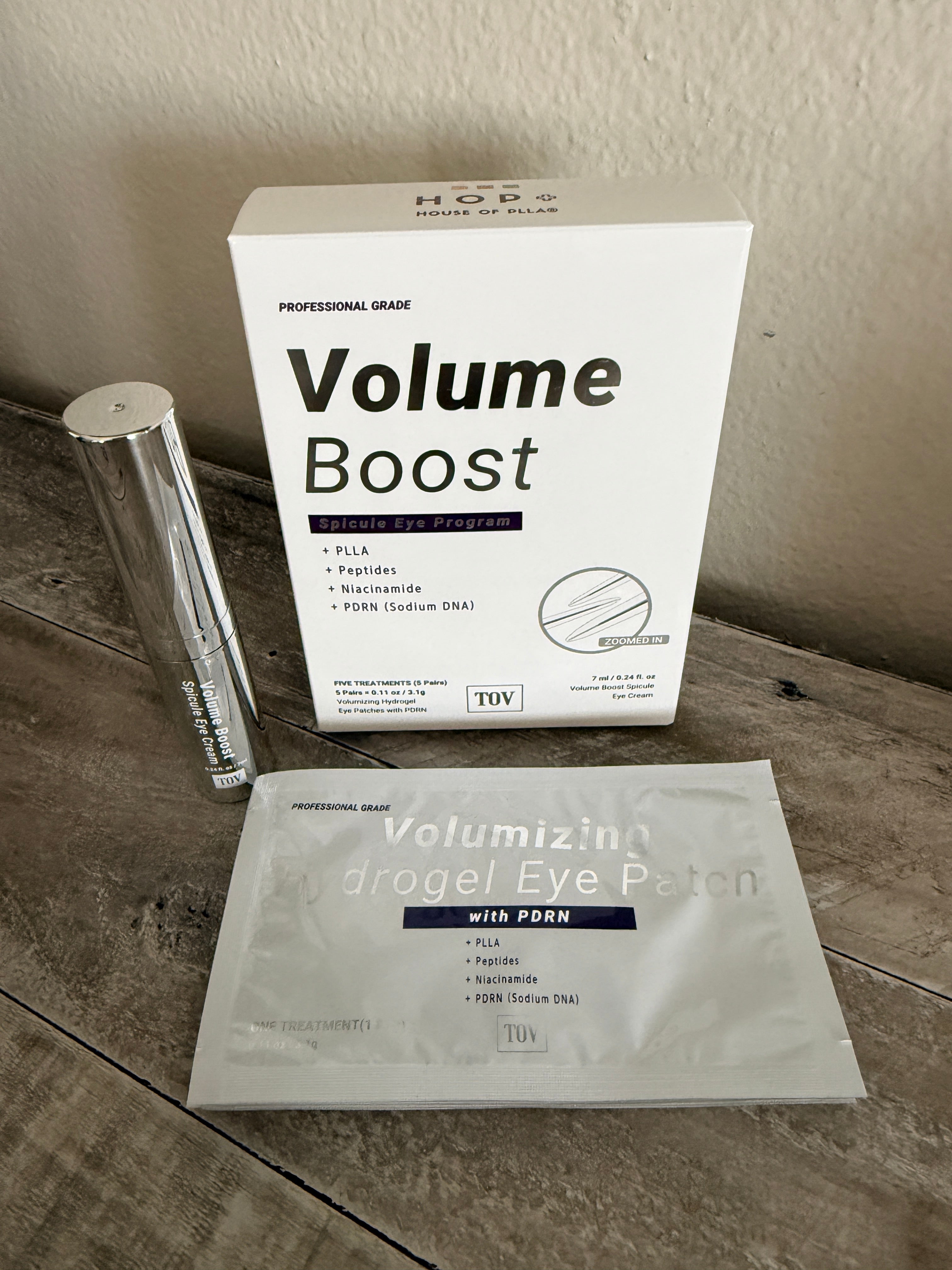 Silver serum bottle next to Eye Patches and white box container for The Volume Boost Spicule Eye Program