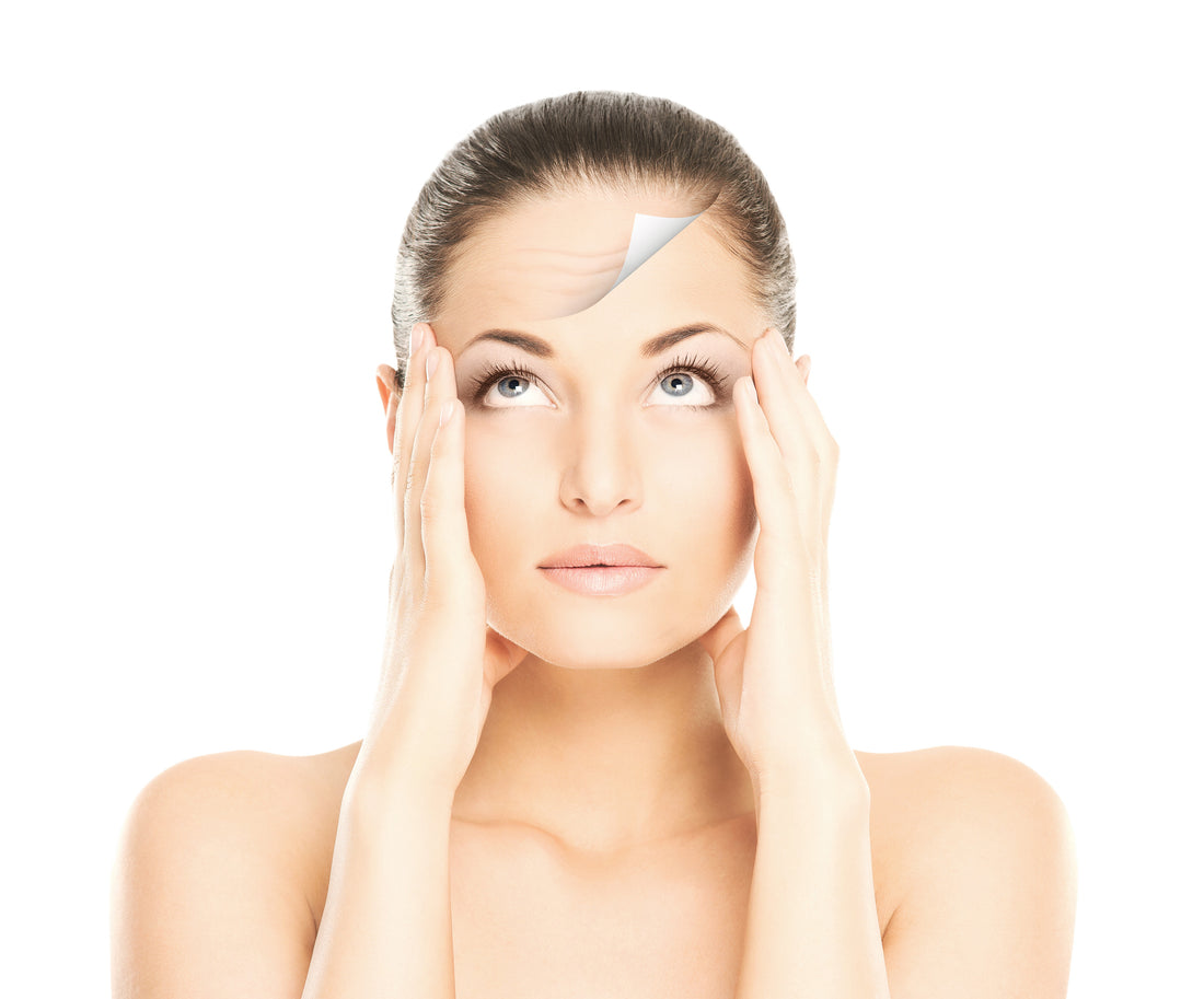 A woman appears to be getting a facial treatment with a serum applied to her face, with a device possibly used for the application visible on her forehead.